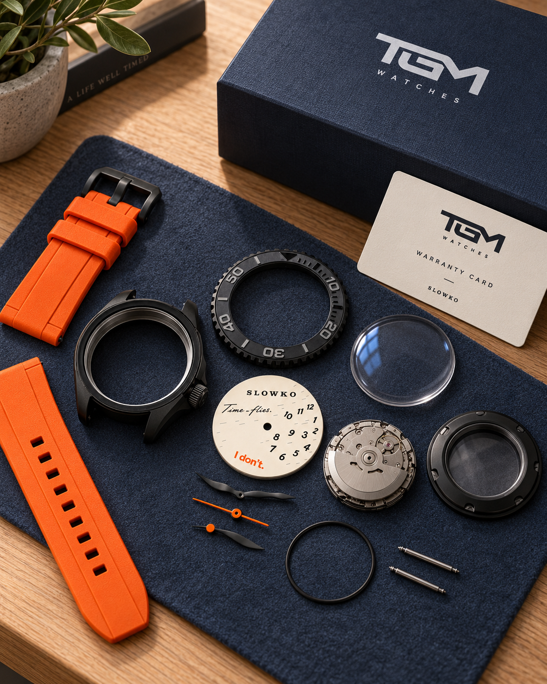 SLOWKO components arranged on a workbench beside a TGM watch box and warranty card.